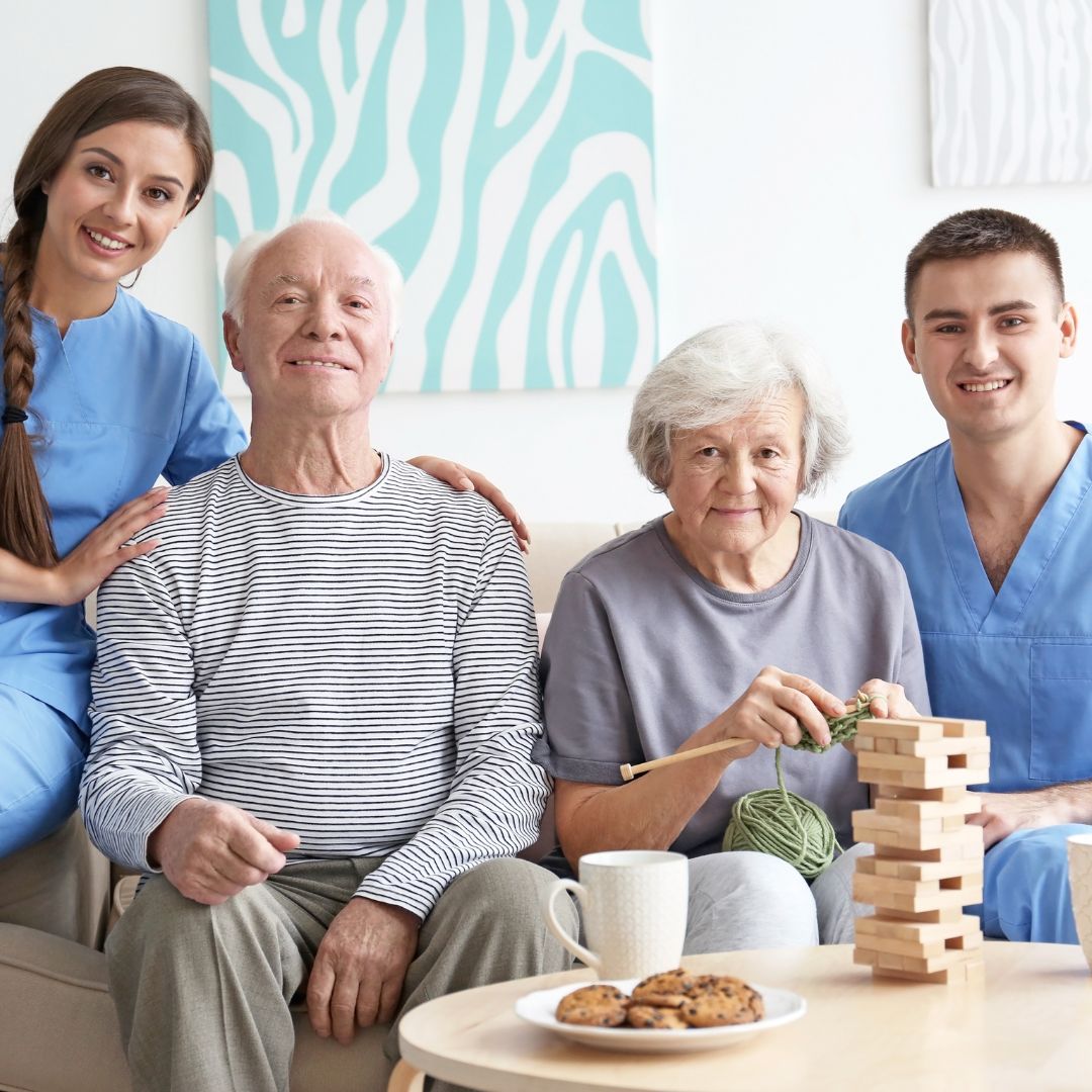 elderly people and caregivers enjoying food and games