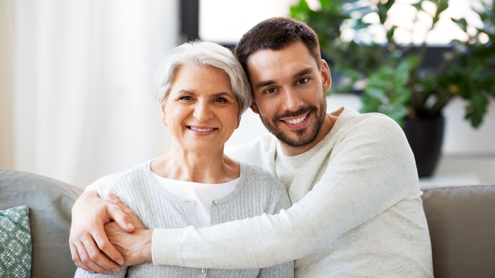 son hugging his elderly mother