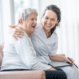 Nurse sitting next to the person she is helping