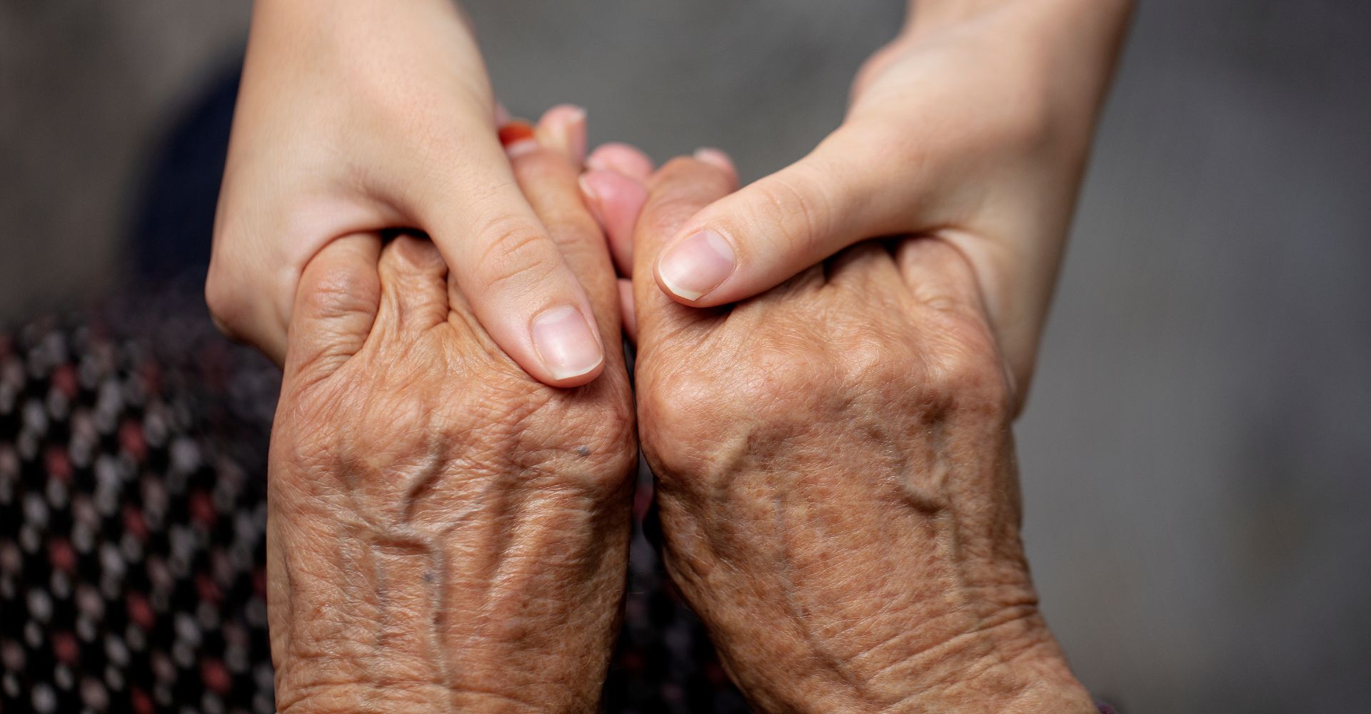 two people different ages holding hands
