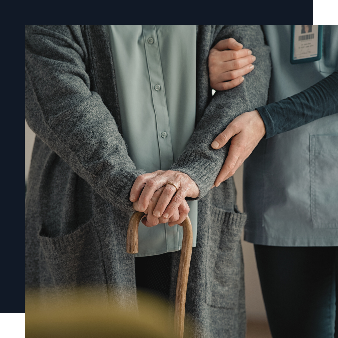 caregiver helping elderly woman